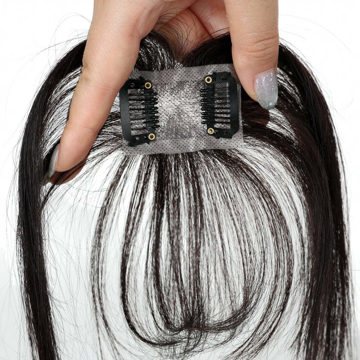 Dark chocolate brown fringe hairpiece underside showing the base and two black clips