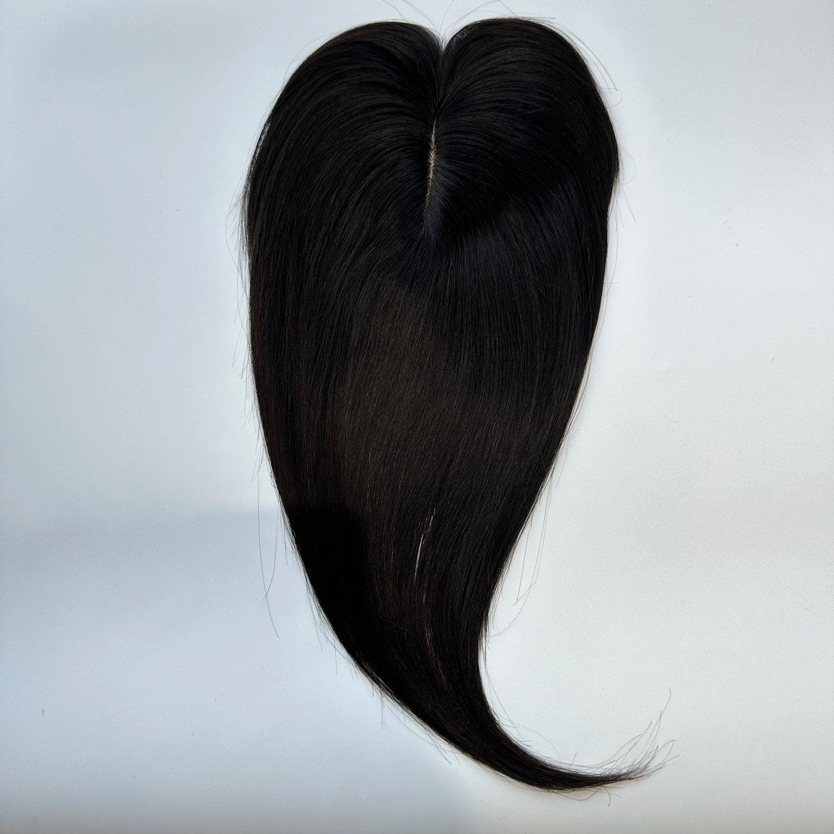 Straight human hair topper in colour 1B, product top view