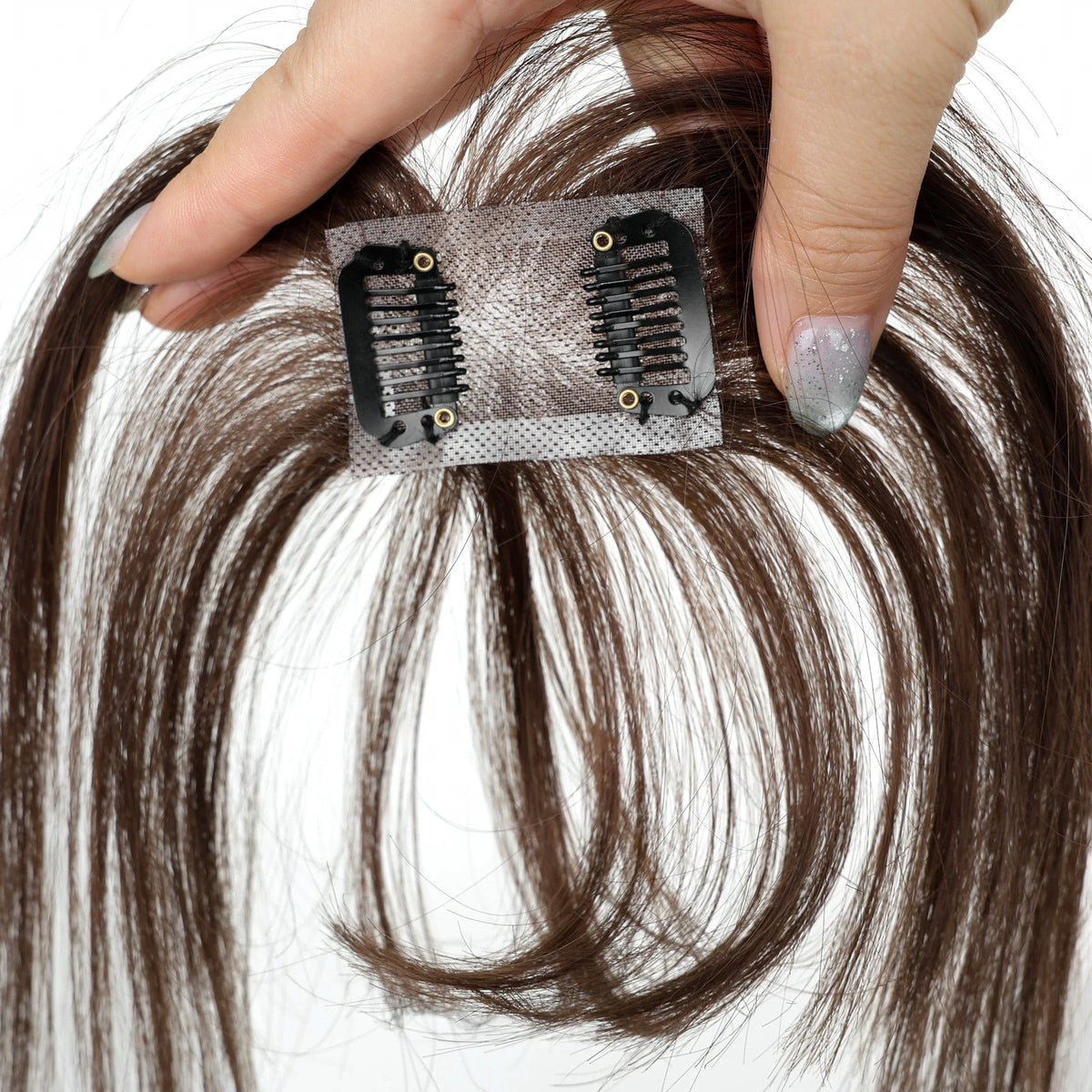 Warm chestnut brown fringe hairpiece underside showing the base and two black clips