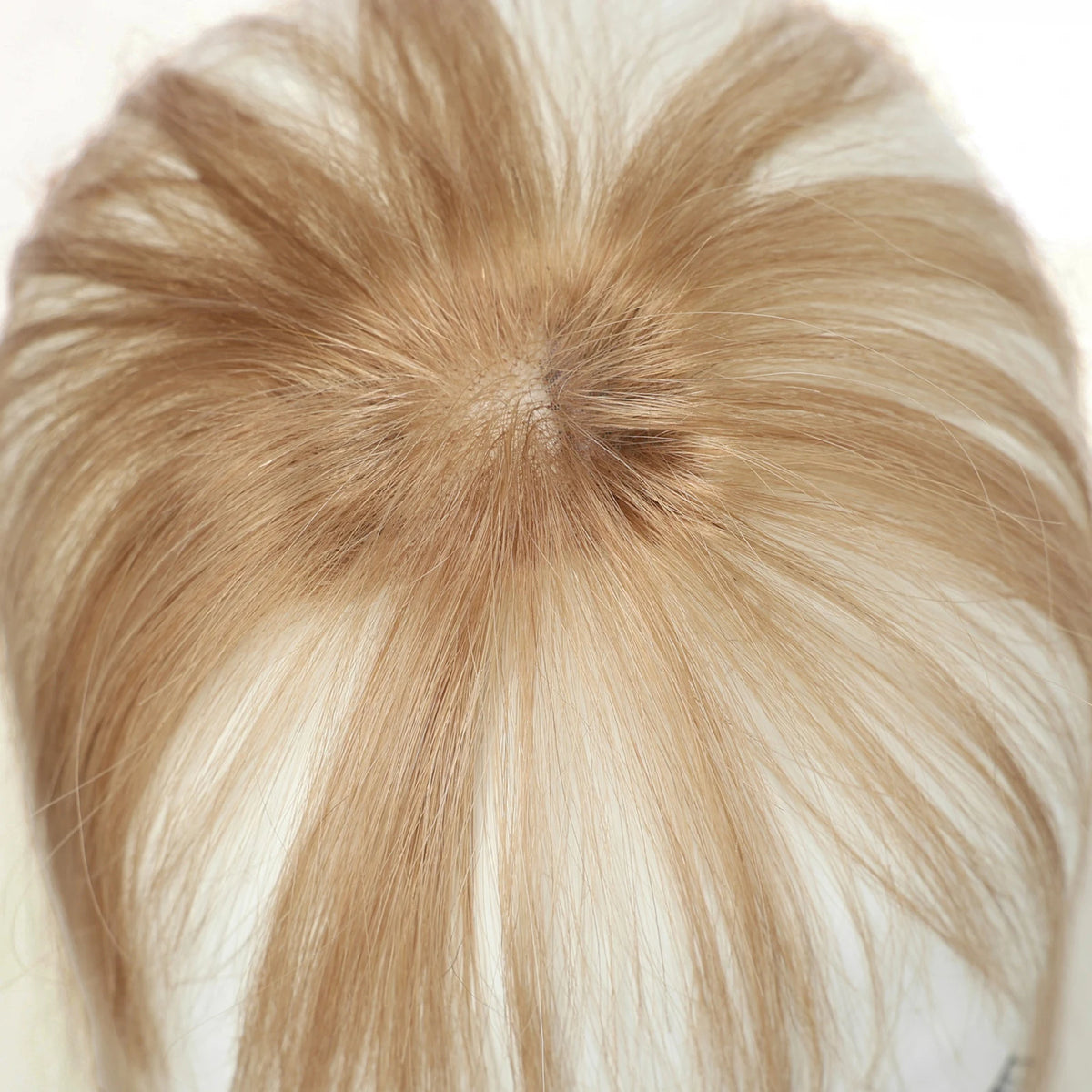 Warm champagne blonde fringe hairpiece showing the top and hair parting