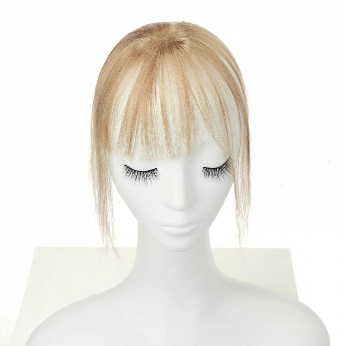 Warm champagne blonde wispy clip-in fringe with side strands, front mannequin view